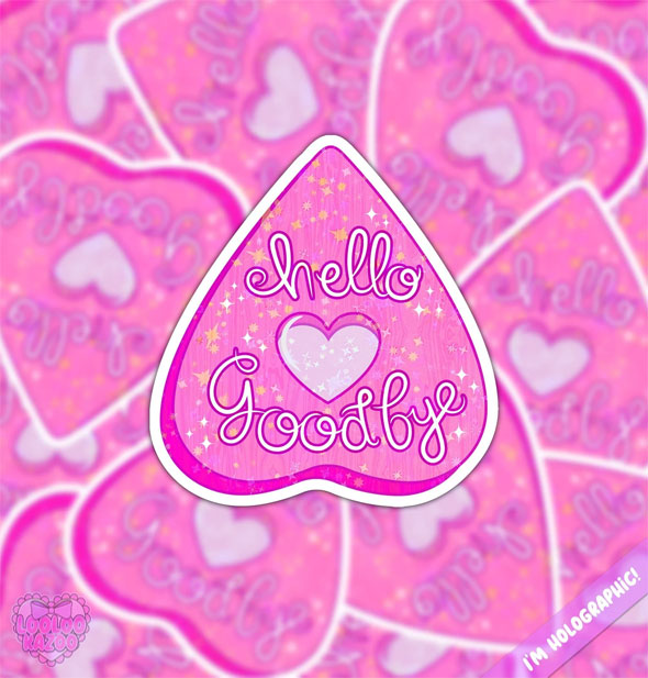 Pink sparkly Ouija board planchette ticker with heart in the center says, "Hello" and "Goodbye" in script lettering and rests against a blurred backdrop of others like it