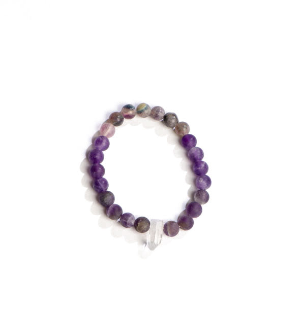 Beaded bracelet with purple stones accented with a central clear crystal point