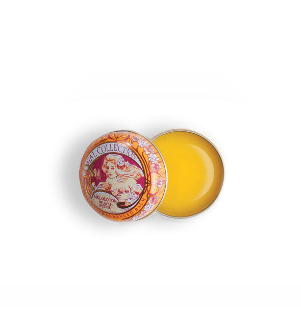 Opened tin of bright yellow peach-flavored Gal Collection lip balm with highly decorative Art Nouveau style artwork
