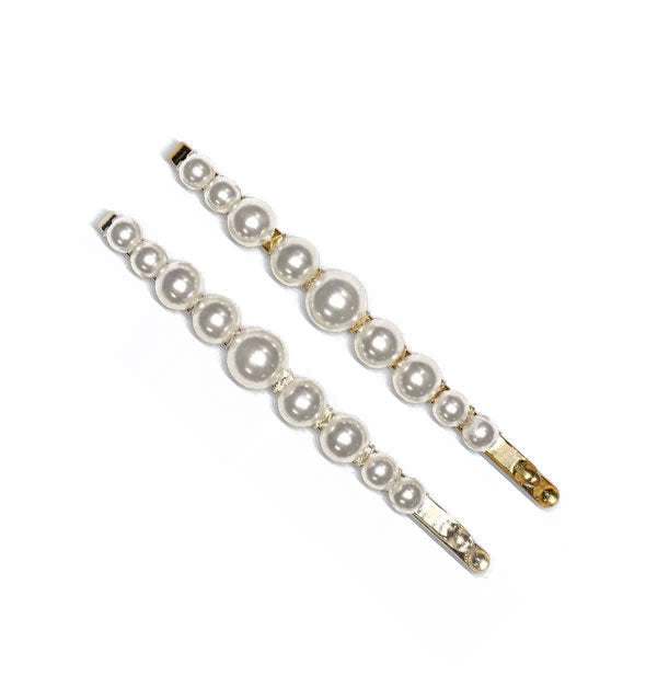 Two gold bobby pins with pearls attached