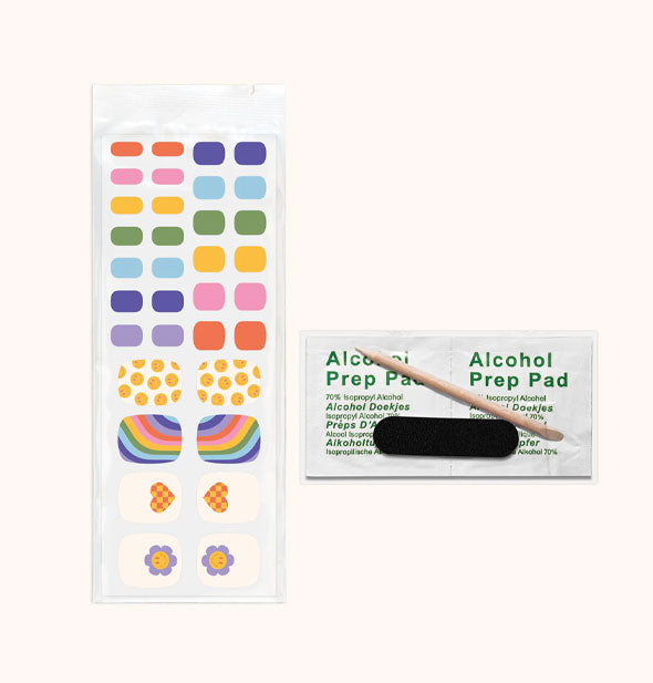 Pedicure Nail Wrap Kit contents: rainbow-themed stickers, alcohol pad, and cuticle stick