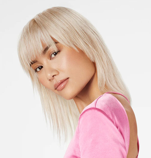 Model with head tilted has healthy-looking platinum hair