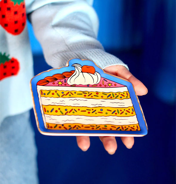 Model's hand holds a Piece of Cake Trinket Tray