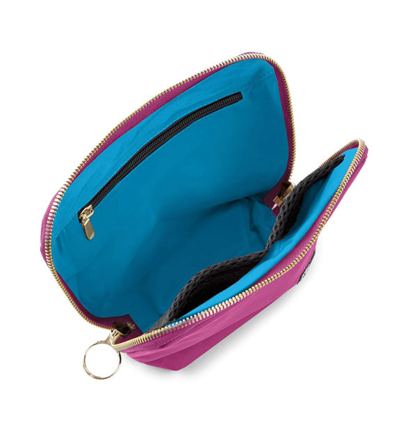 Fully unzipped Everyday Makeup Bag reveals blue lining and interior zip and mesh pockets