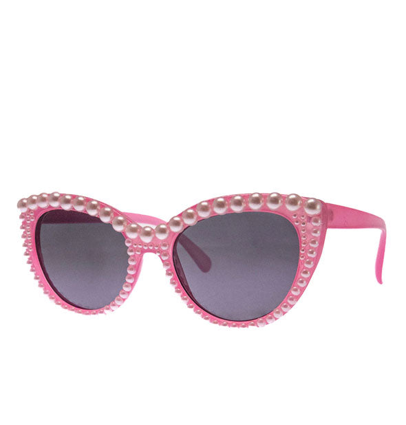 Pink cat eye sunglasses with pearls covering the front
