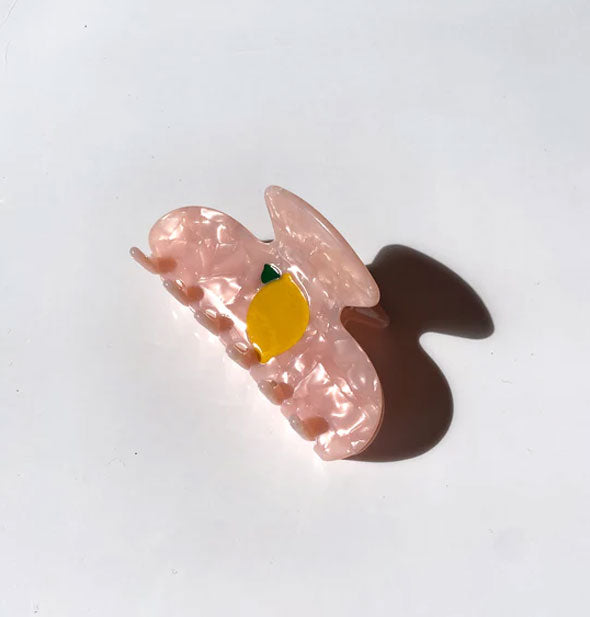 Pink quartz-effect hair claw clip with yellow lemon design in the center