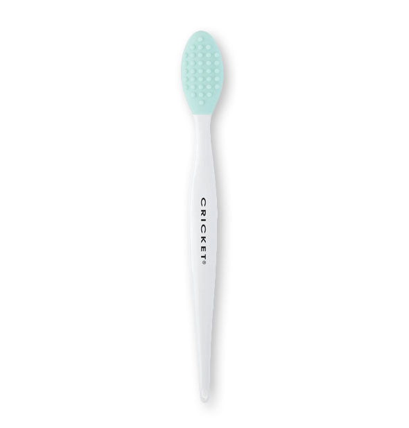 Cricket brush for lip exfoliation features a teal brush head with coarse bristle pattern