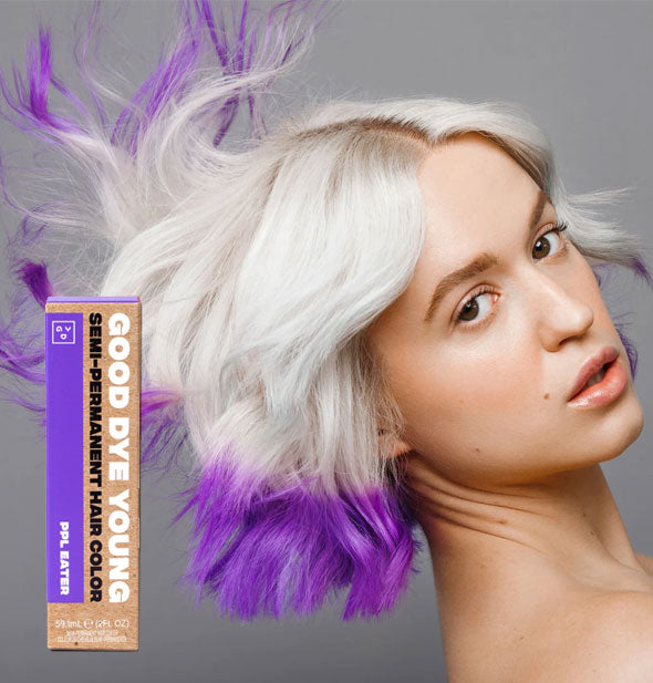Model wears bright purple ends on platinum hair; box of Good Dye Young Semi-Permanent Hair Color in shade PPL Eater is inset at bottom left