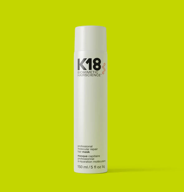 White 5 ounce bottle of K18 Biomimetic Hairscience Leave-in Molecular Repair Hair Mask on a bright lime green background