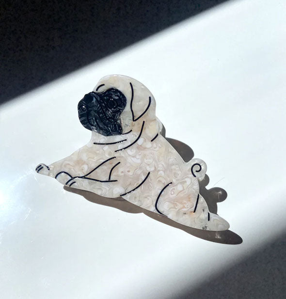 Hair claw clip designed and painted to resemble a pug dog