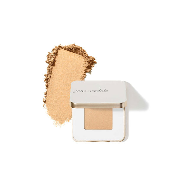 Opened square white and gold Jane Iredale eye shadow compact with sample product application at left in the shade Pure Gold