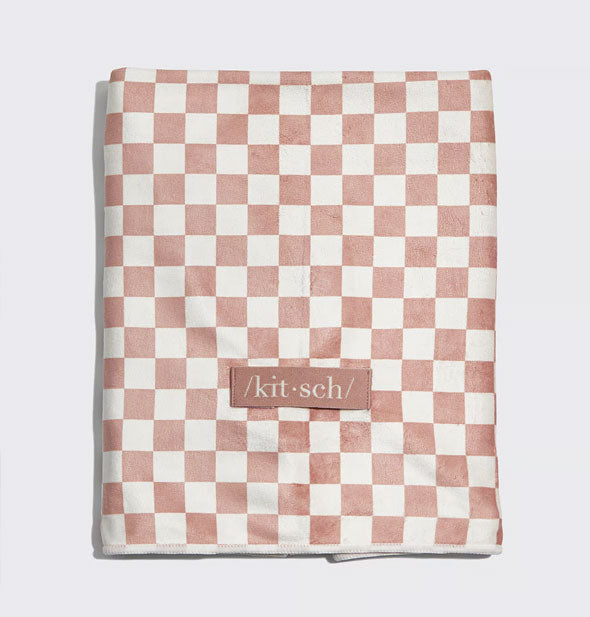 Muted terracotta and white checker print hair towel with sewn-on Kitsch label