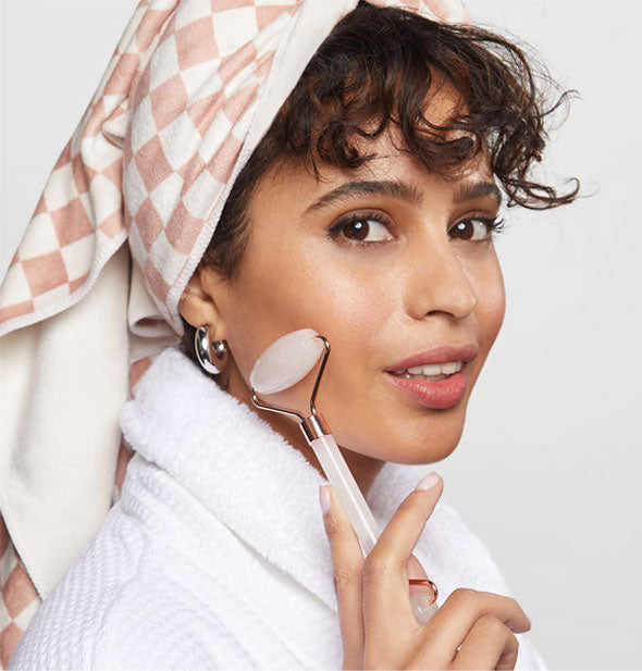 Model massaging face with a roller demonstrates wear of the Quick-Dry Hair Towel Wrap