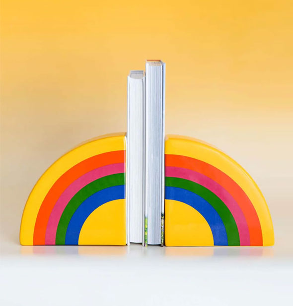 Rainbow bookends staged with two booksbetween them