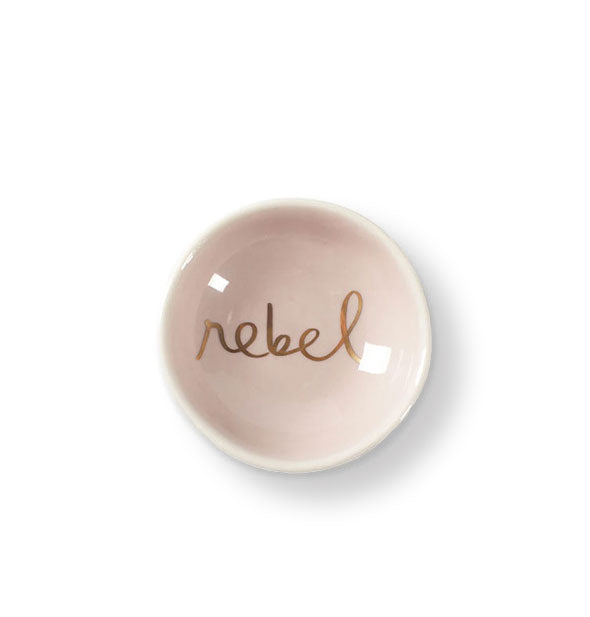 Round pale pink dish says, "Rebel" in the bottom in metallic gold script