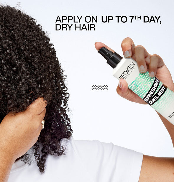 Model applies Redken Refreshing Curl Mist to tight coils below the caption, "Apply on up to 7th day dry hair"