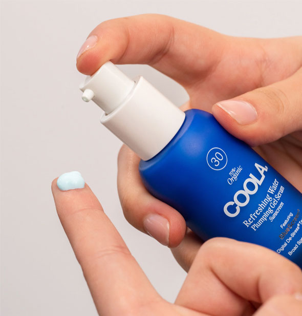 Model applies a small dollop of Coola Refreshing Water Plumping Gel Serum to fingertip