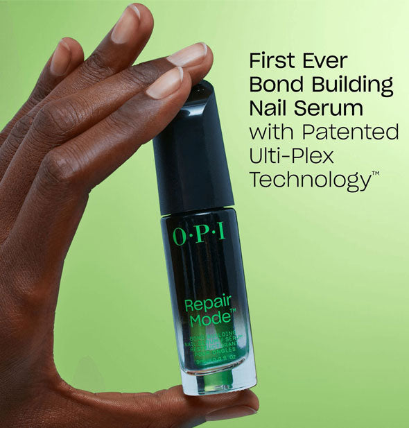 Model's hand holding a bottle of OPI Repair Mode is labeled, "First Ever Bond Building Nail Serum with Patented Ulti-Plex Technology™"