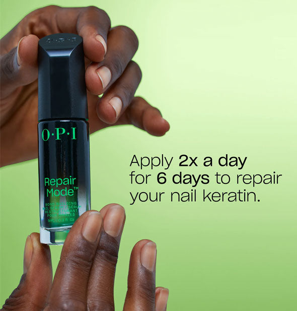 Model's hands holding a bottle of OPI Repair Mode next to label reading, "Apply 2x a day for 6 days to repair your nail keratin."