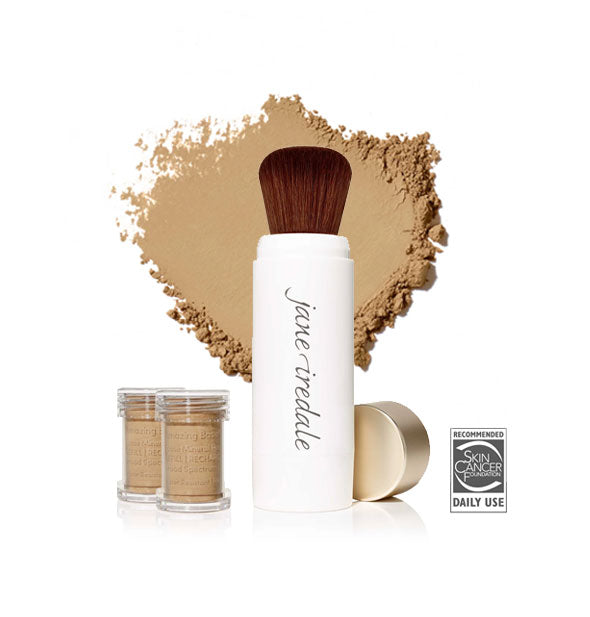 White Jane Iredale powder brush with gold cap removed and set to the side, two refill canisters nearby, and an enlarged product sample in the background in shade Riviera