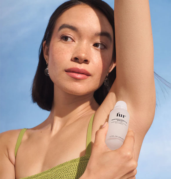 Model applies Fur Ingrown Eliminator Serum Rollerball to underarm