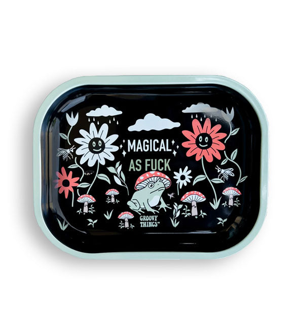 Black rectangular tray with light green rim and rounded corners features illustrations of a frog with mushroom cap hat, other mushrooms, smiling flowers, clouds, and the words, "Magical as fuck" in the center