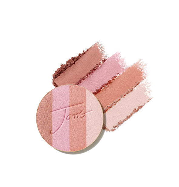 Four-shade bronzer pressed powder compact refill disc stamped with "Jane" is placed in front of crumbled and streaked applications of each shade in Rose Dawn option