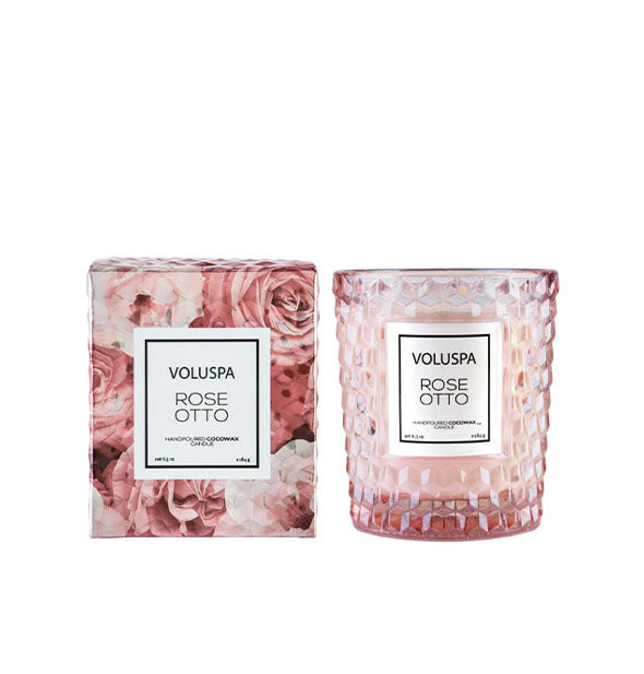 Textured pink Voluspa Rose Otto candle jar next to decorative gift box with rose patterning