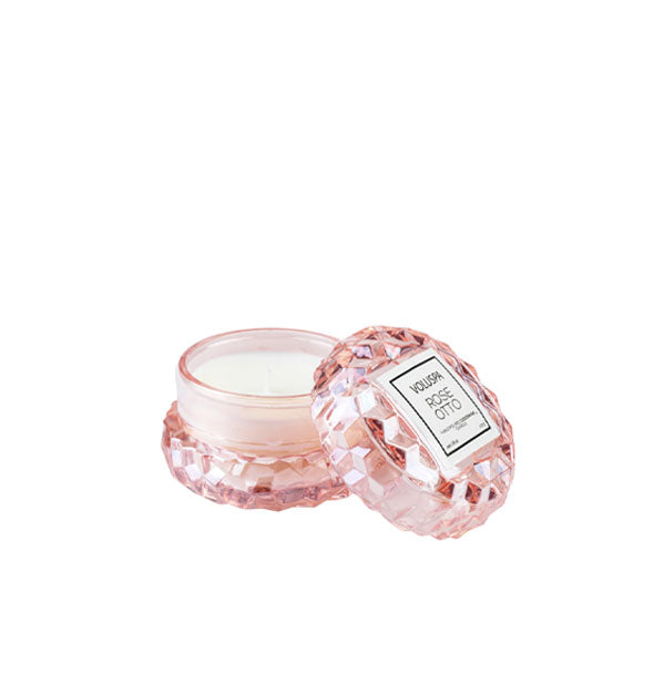 Mini iridescent pink textured Voluspa Bergamot Rose Candle Jar with matching lid removed and propped alongside