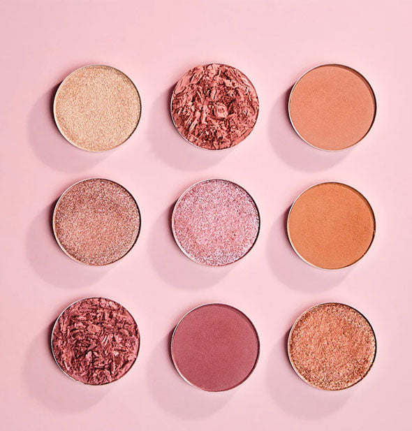 Nine round eyeshadow pots with a rosy color scheme