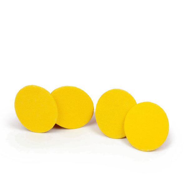 Four yellow cloth discs are socks folded to resemble flat potato chips