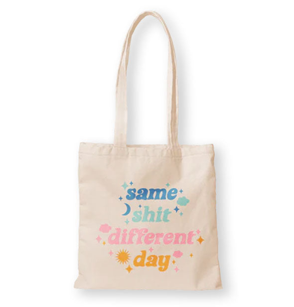 Cream colored tote bag says, "Same Shit Different Day" in multicolored lettering accented by celestial symbols