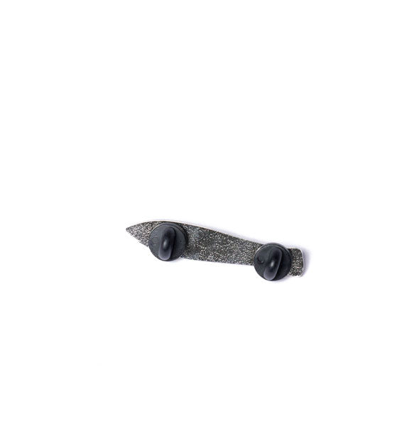 Back of sardine pin shows two black rubber backings