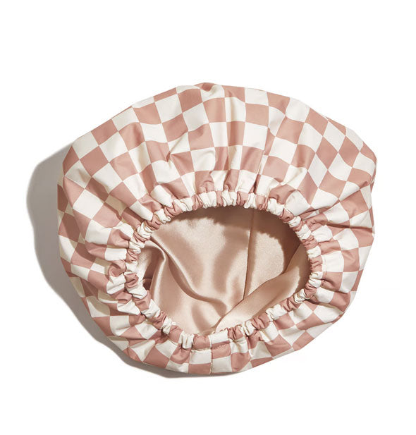 White and terracotta checker print shower cap with elastic opening and satin lining