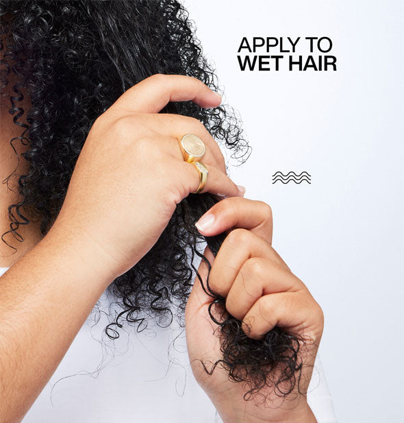 Model applies Redken Sculpting Curl Gel to damp coily curls alongside the caption, "Apply to wet hair"