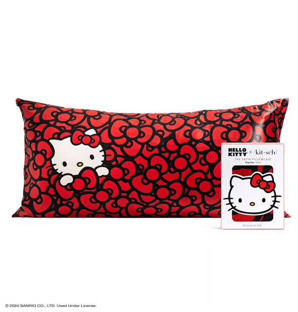 Package of one Hello Kitty x Kitsch Satin Pillowcase with king size pillowcase shown behind featuring an all-over red bow pattern and Hello Kitty's white face and paws peeking out at left