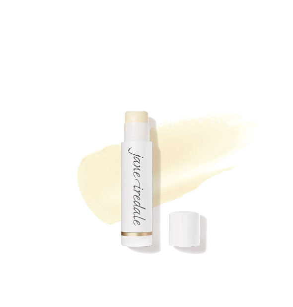 White tube of Jane Iredale lip balm with cap removed overtop a sample application of product in a sheer shade