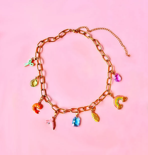 Gold charm necklace with large links and a length extender features 8 colorful charms: scissors, shrimp, hot glue gun, ear of corn, rainbow, and three gems