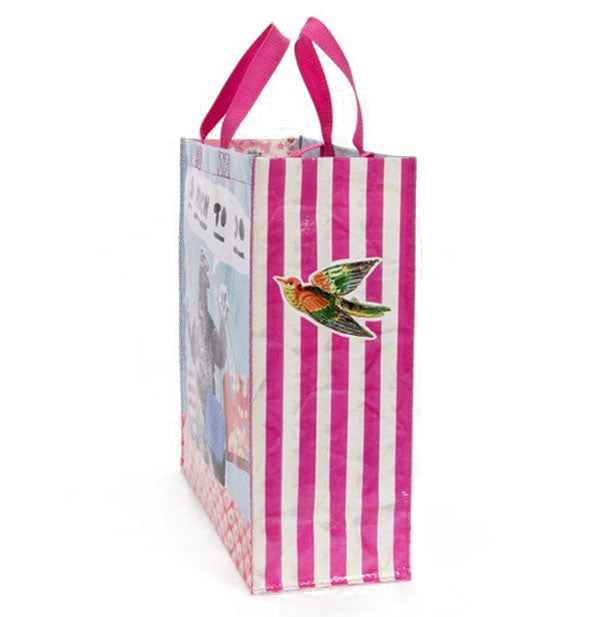 Side of a tote bag with pink handles and stripes and colorful bird graphic