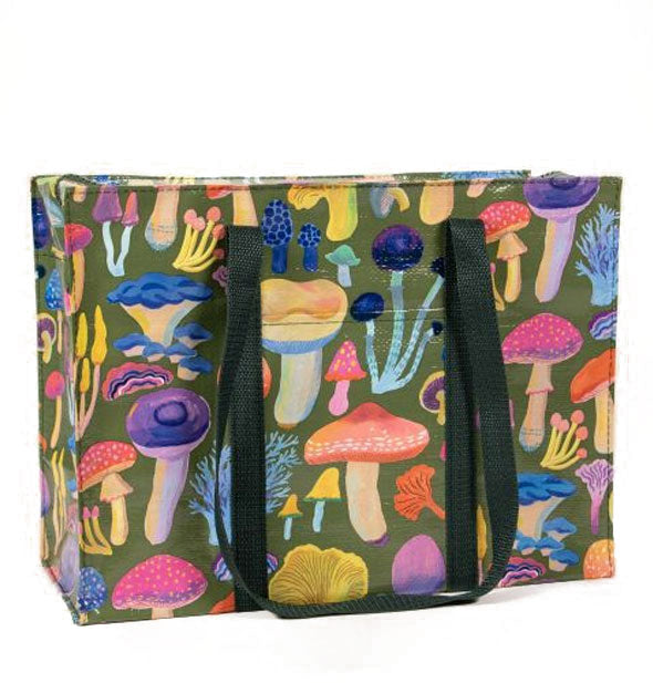 Large rectangular tote bag with dark green handles features colorful all-over mushroom illustrations on a green background