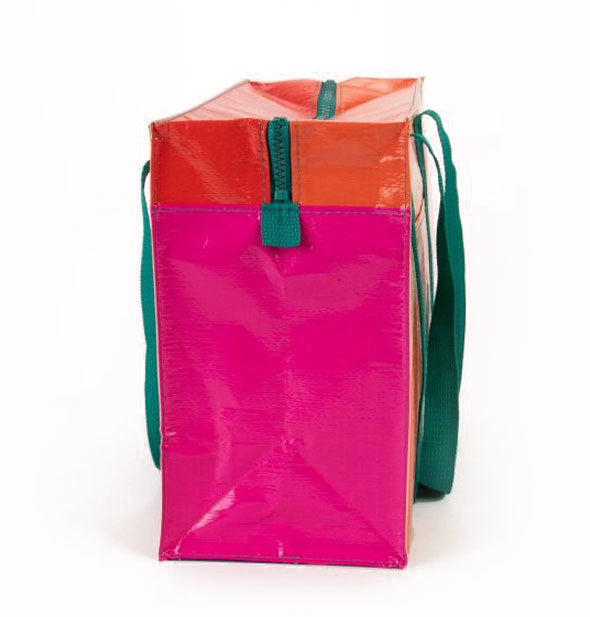 Rectangular bag side view with pink side panel, red top panel, green top zipper, and green shoulder straps visible