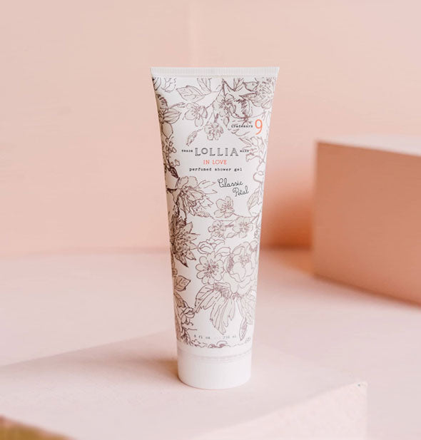 White 8 ounce tube of Lollia In Love Classic Petal Perfumed Shower Gel with intricate all-over floral design