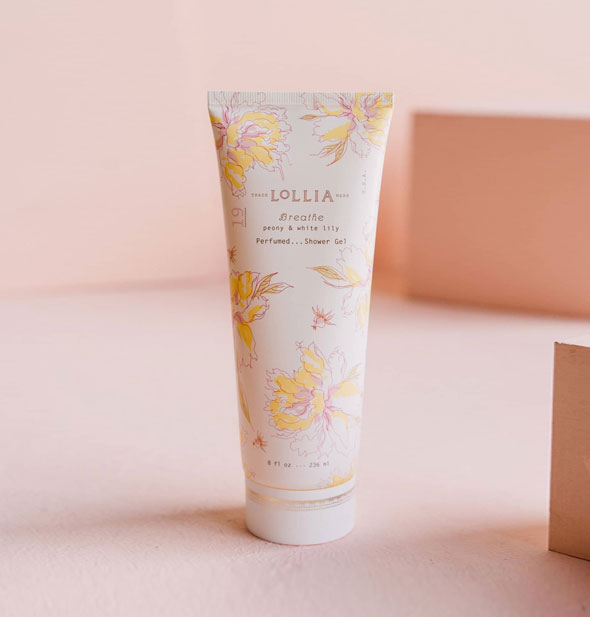 White tube of Lollia Breathe Peony & White Lily Perfumed Shower Gel with delicate pink and yellow floral designs
