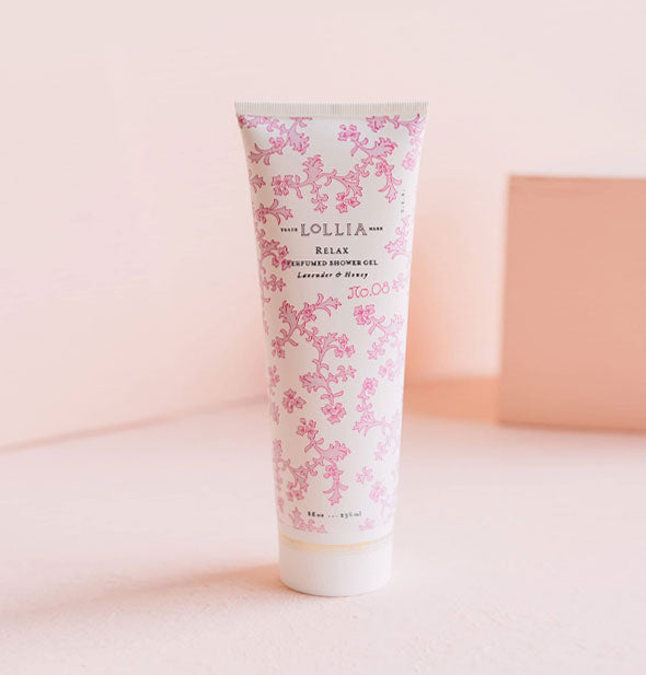 White 8 ounce Lollia: Relax Perfumed Shower Gel bottle in Lavender & Honey fragrance features all-over pink floral pattern