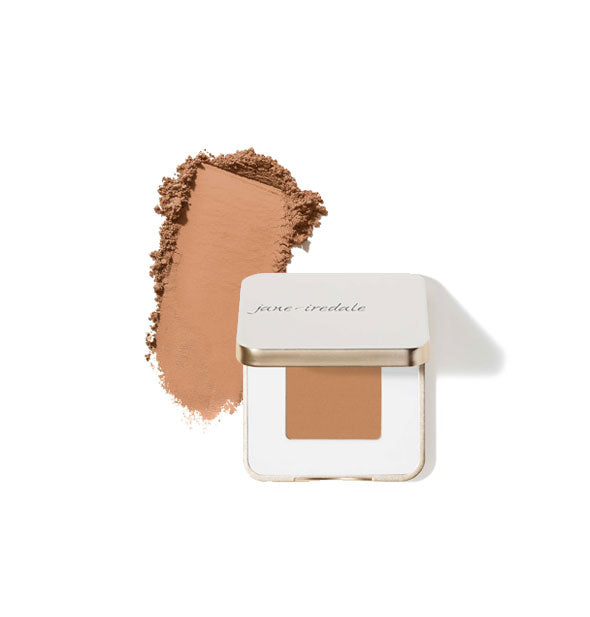 Opened square white and gold Jane Iredale eye shadow compact with sample product application at left in the shade Sienna