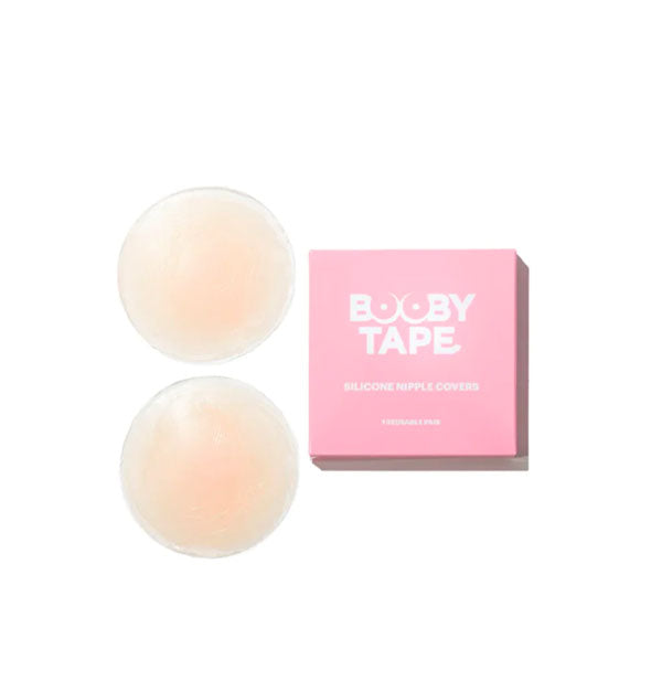 Set of two light-colored Silicone Nipple Covers by Booby Tape next to pink and white box