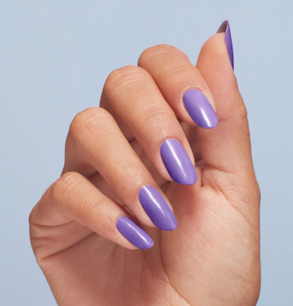 Model's fingernails are painted with purple polish
