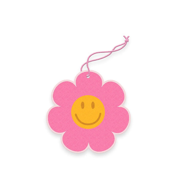 Pink flower-shaped air freshener on pink string features a central yellow smiley face