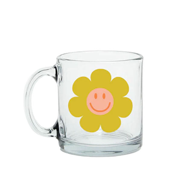 Clear glass mug features a mustard yellow and pink flower graphic with central smiley face