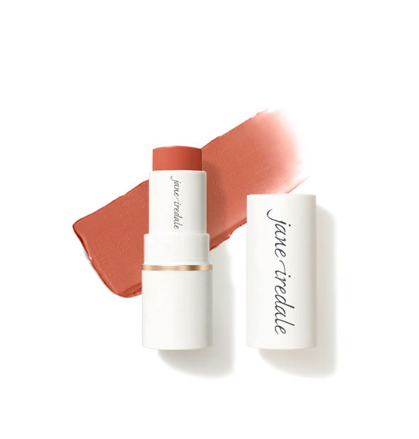 White tube of Jane Iredale Glow Time Blush Stick with cap removed and sample product application behind in matte shade Smolder
